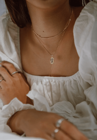 woman wearing silver and gold jewelry pieces
