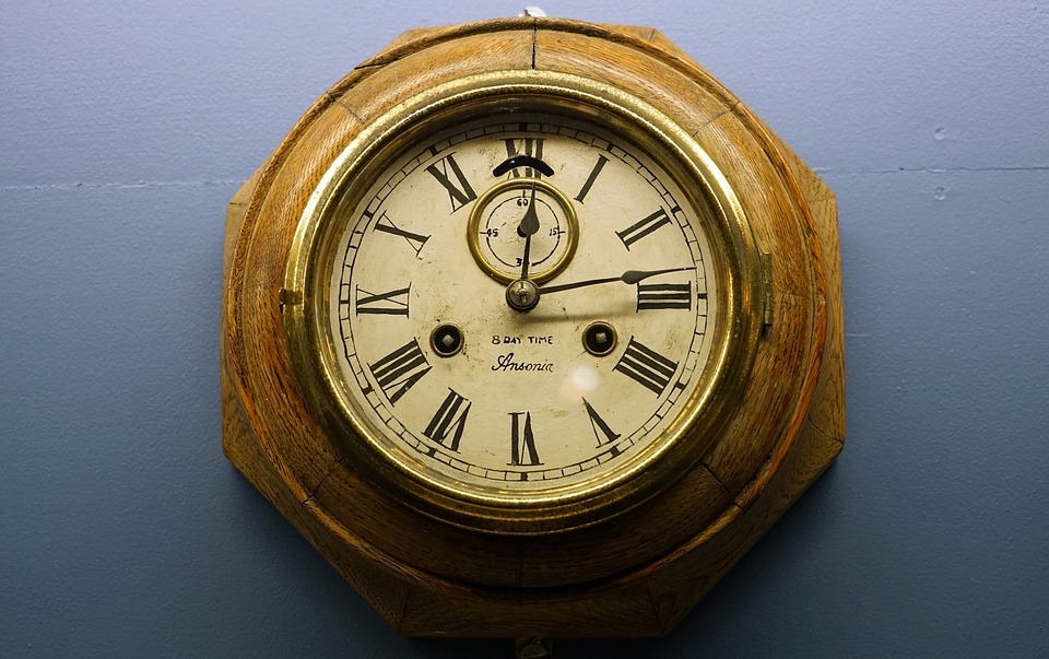 an antique wooden wall clock